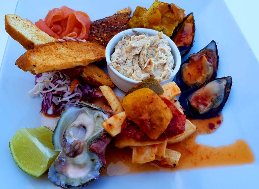 rtfully arranged seafood platter with fresh shellfish and accompaniments at Melkbosstrand, Cape Town