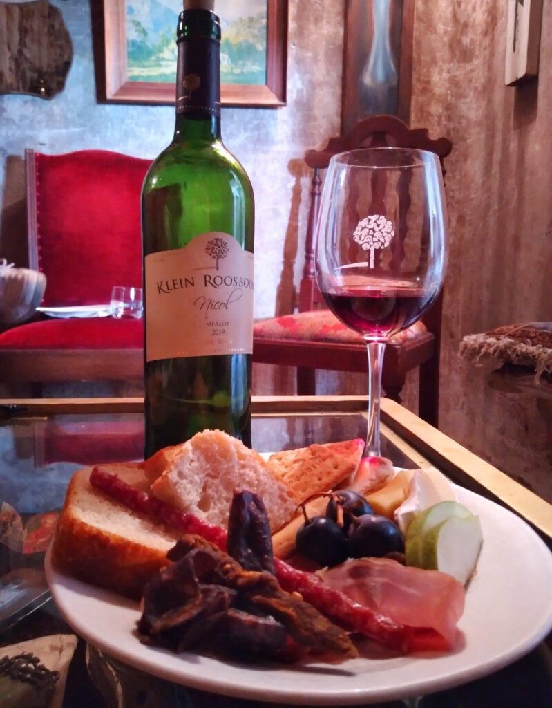 Merlot Red wine served in a glass alongside finger food during a tasting at Klein Roosboom Winery